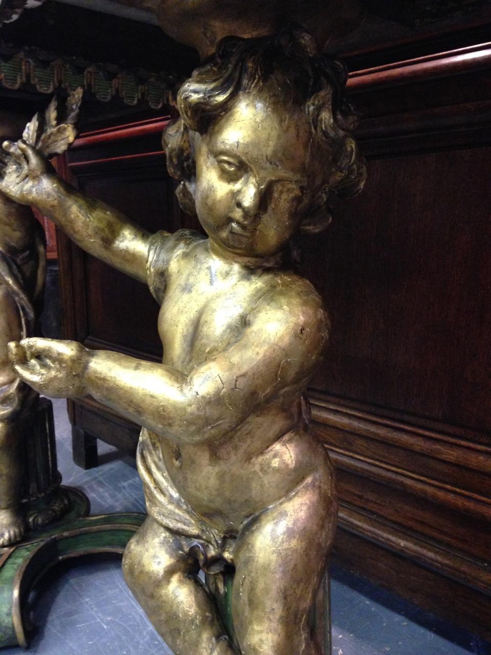 Pair of Gilded and Carved Cherub Console Tables 